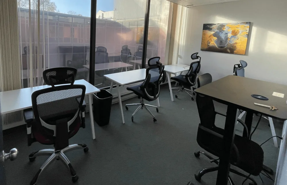 Furnished windowed team office with five desks at US Executive Center