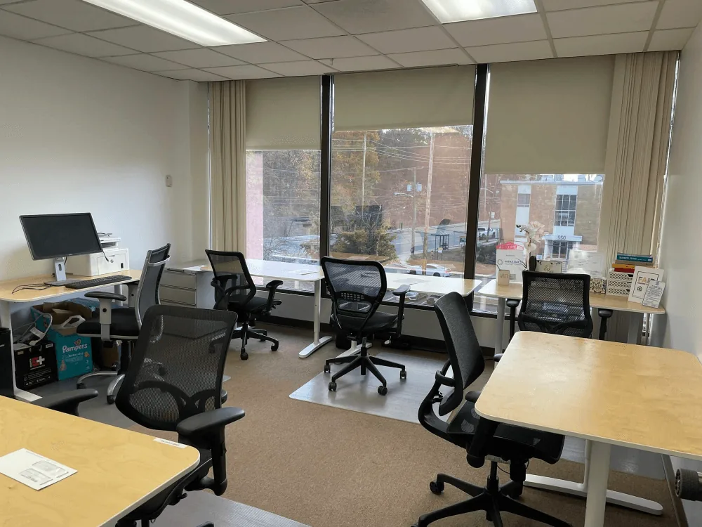 Multi-desk team office with large windows in Englewood Cliffs