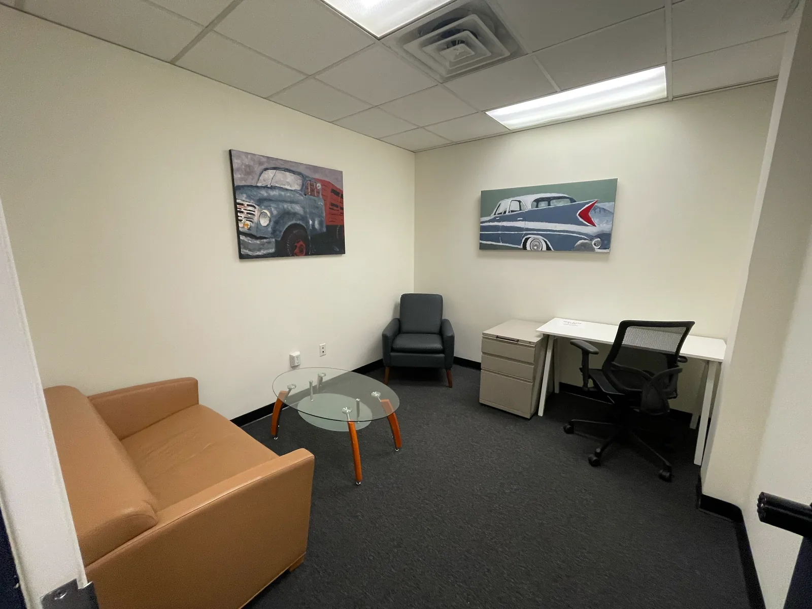 Furnished private day office with desk and client seating